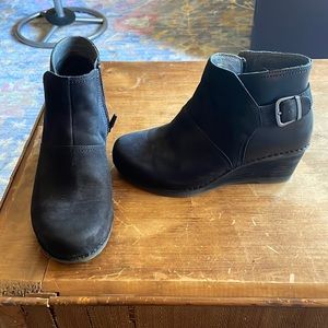 Black Dansko ankle boot with zipper and a buckle as an accent. Great condition.